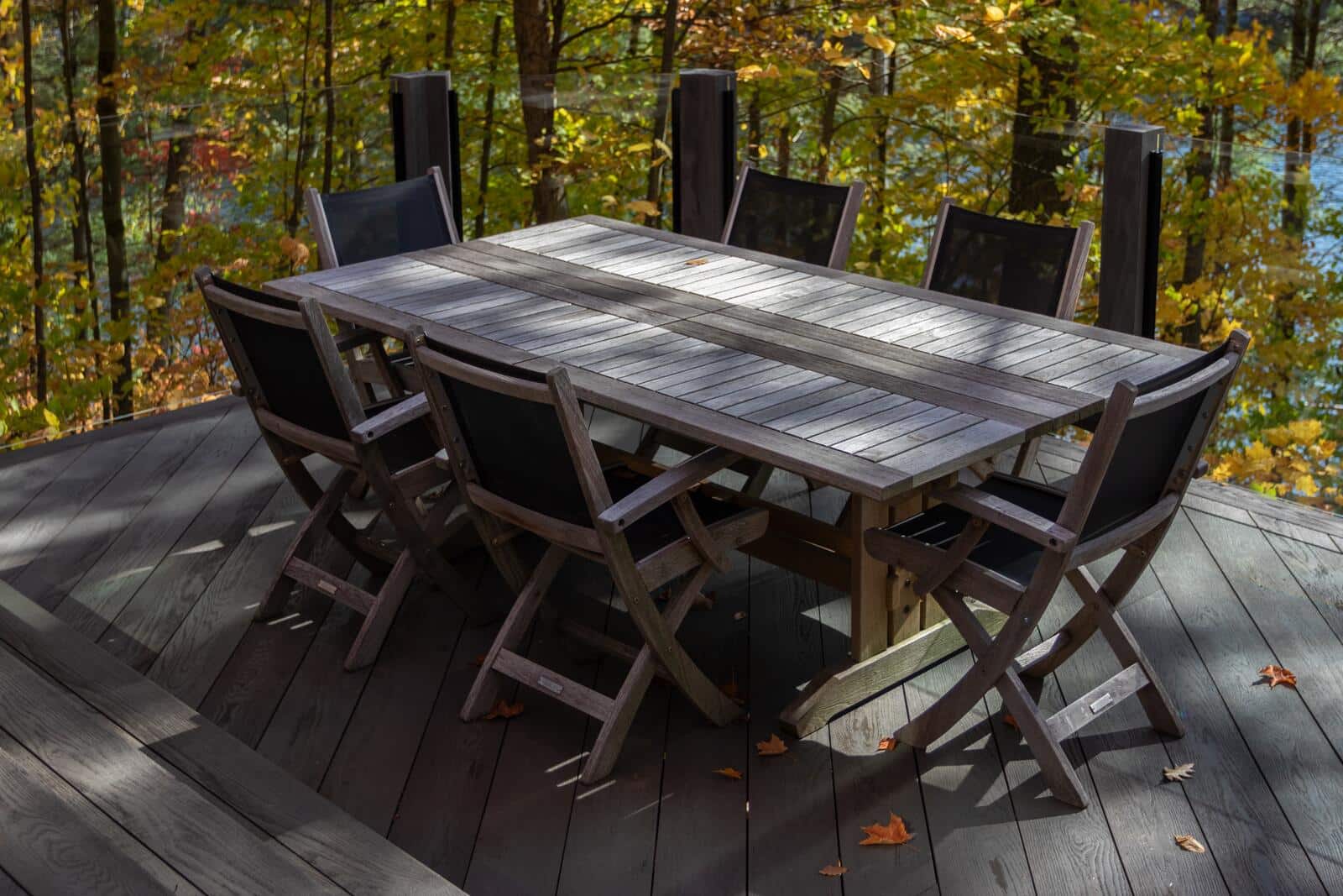 Cottage deck with outdoor dining table and fall colours in Muskoka