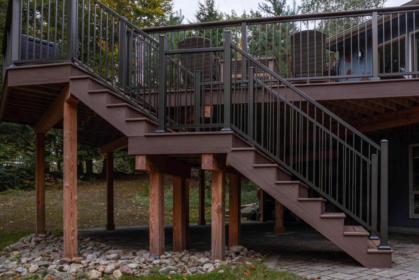 Elevated deck on timber posts with stairs and aluminum railing in Muskoka