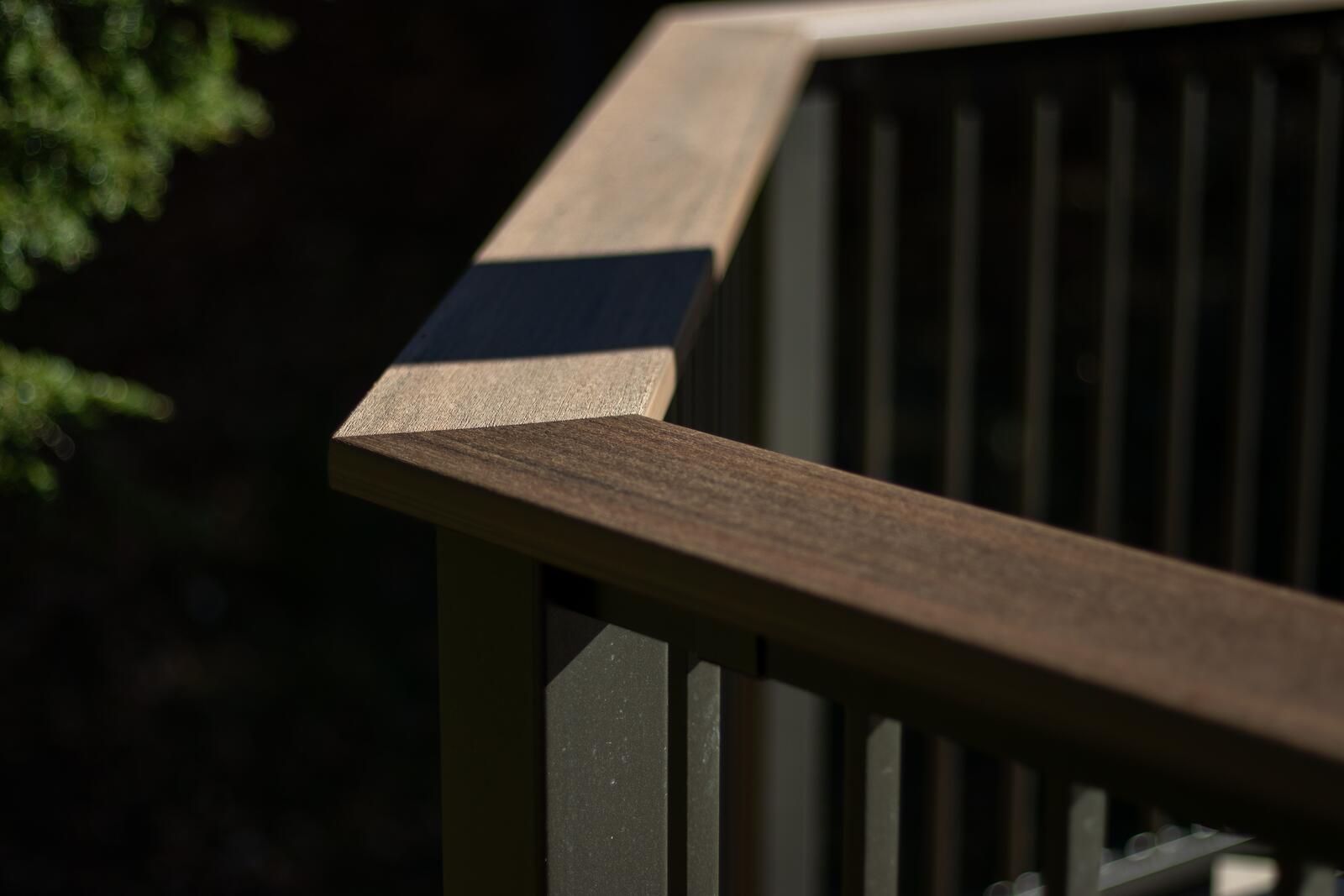 Close up of a mitred hardwood deck railing corner built in Muskoka