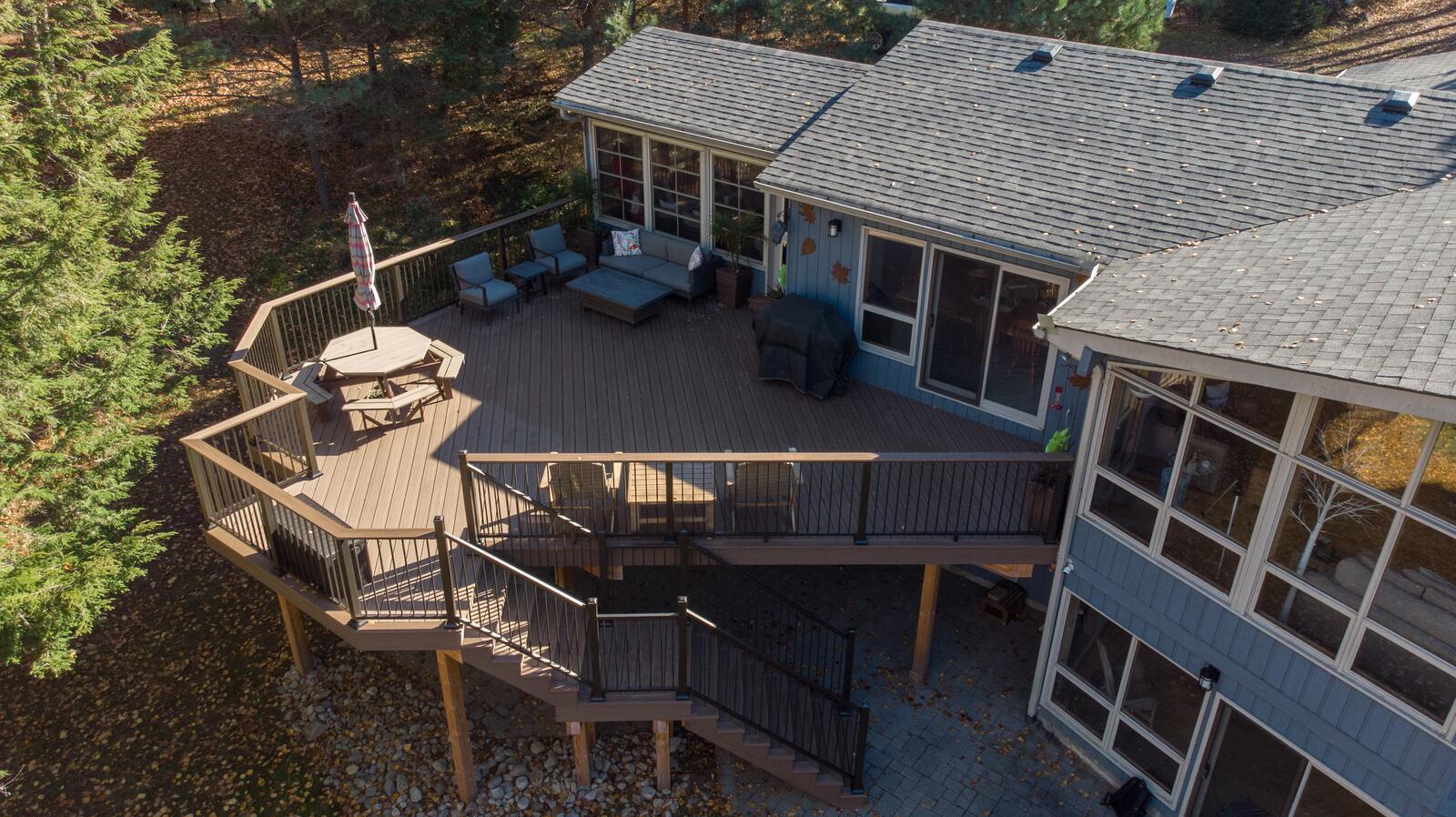 Aerial view of a multi-level residential deck wrapping a home in Muskoka