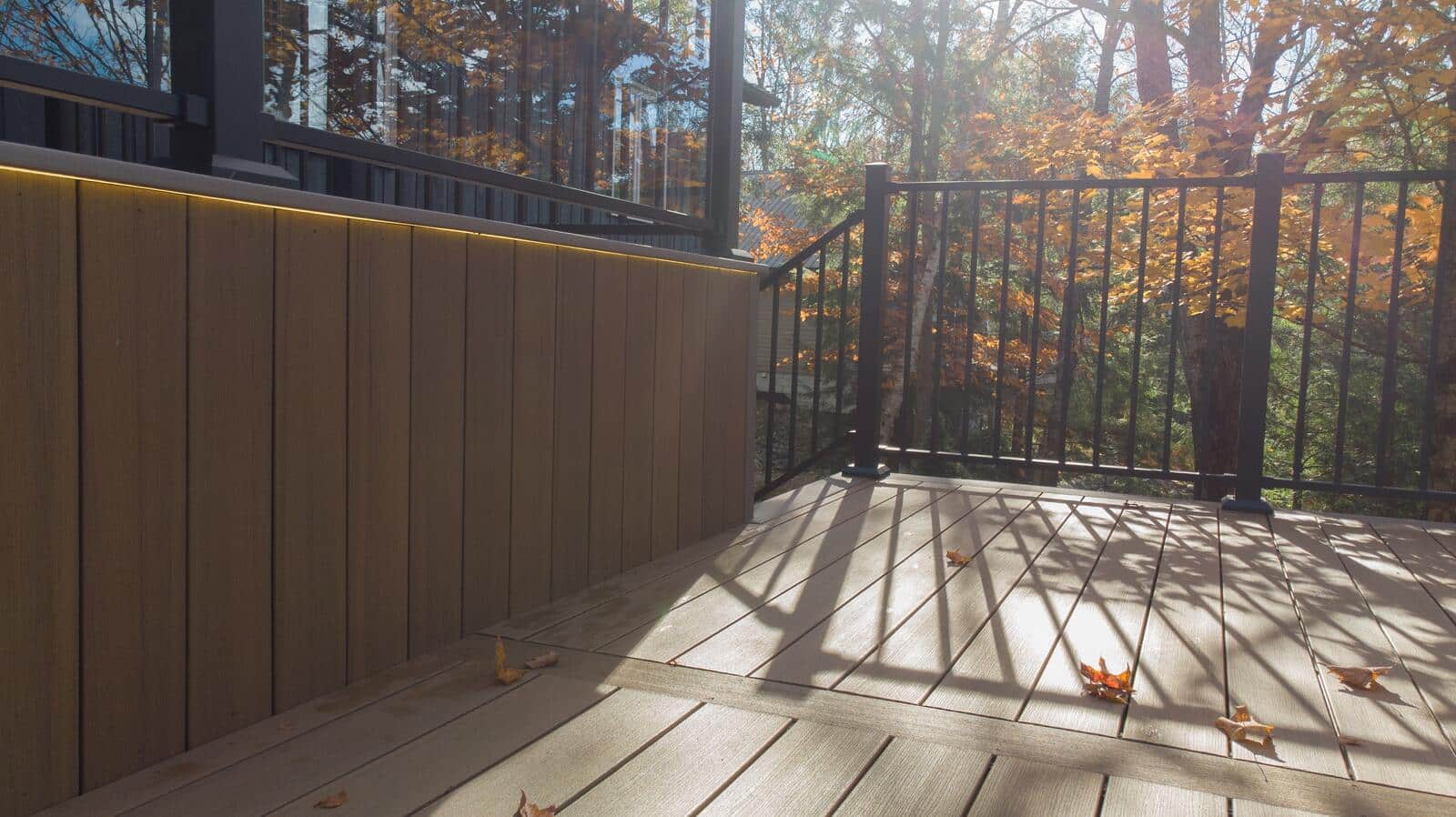Deck privacy wall with integrated lighting and aluminum railing in Muskoka